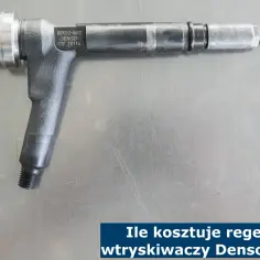 Wtryskiwacz Denso na metalowym blacie. Dowiedz się, ile kosztuje regeneracja wtryskiwaczy Denso.